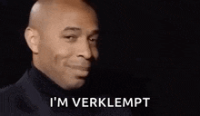 a man in a suit is smiling and saying `` i 'm verklept '' .