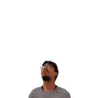 a man with glasses is looking up at a green cross on his head