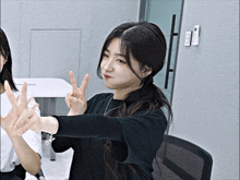 a girl making a peace sign with her hands