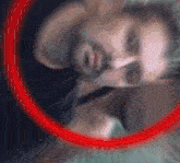 a blurred image of a person with a red circle around them
