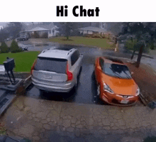a couple of cars are parked next to each other in a driveway .