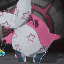 a pink and white stuffed animal with stars on it 's clothes