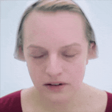 a woman 's face is shown with her eyes closed