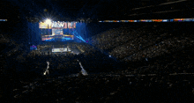 a crowd watching a wrestling event with a crown that says champion