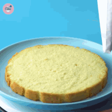 a piece of cake on a blue plate with the word cake on the bottom