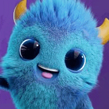 a close up of a blue stuffed animal with horns and a pink tongue sticking out .