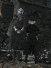 a man and a woman are standing next to each other in a dark room