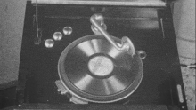 a black and white photo of a record player with a record in it