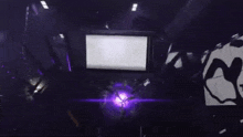 a dark room with a purple light coming out of the top