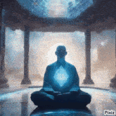 a man sits in a lotus position with a blue light coming out of his chest