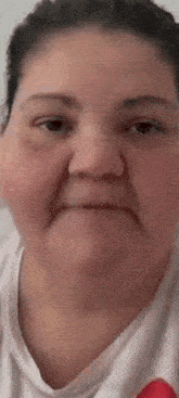 a close up of a woman 's face with a sad expression .