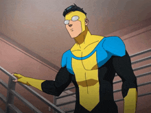 a man in a yellow and blue superhero costume