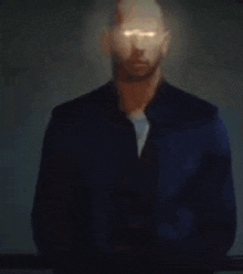 a blurry picture of a man in a suit with a light coming out of his face