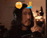 a man wearing headphones with a smiley face on his head