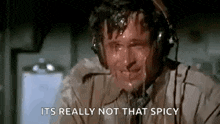 a man wearing headphones is sweating while talking on a phone .