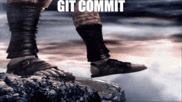 a person is standing on a rock with the words git commit written on the bottom