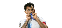a soccer player with a tattoo on his arm covering his mouth with his hands