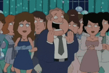 a man in a suit and tie is standing in front of a crowd of women