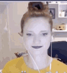 a woman is wearing headphones and a yellow shirt .