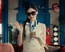 a woman wearing sunglasses and a scarf with a sticker that says ' gucci ' on it