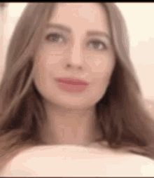 a blurry picture of a woman 's face with long hair