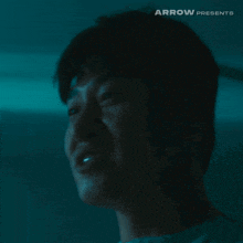 a close up of a man 's face with arrow presents written above him