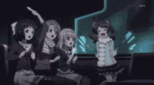 a group of anime girls are sitting on a couch and watching a movie .
