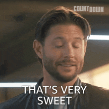 a man with a beard says that 's very sweet with his eyes closed
