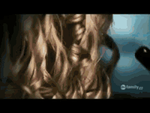a close up of a woman 's hair with the words family on the bottom left