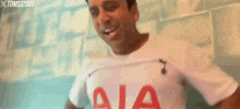 a man is wearing a white shirt with aia on it