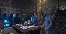 a group of men in blue robes are standing around a table with a clock that says 1:10