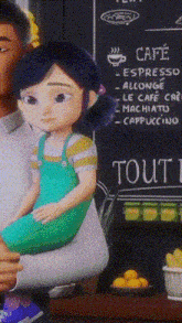 a little girl is sitting on a man 's lap in front of a sign that says cafe espresso