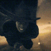 a person in a top hat is flying through the air