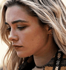 a close up of a woman 's face with earrings on
