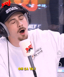 a man wearing headphones and a hat that says hello world on it