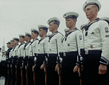 a group of men in military uniforms are standing in a row