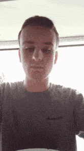 a man wearing a shirt that says macpac on the front