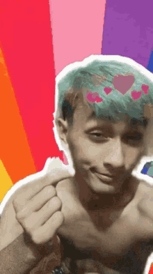 a shirtless young man with green hair and hearts on his head .