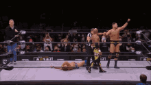 two wrestlers in a ring with the word all elite on the wall