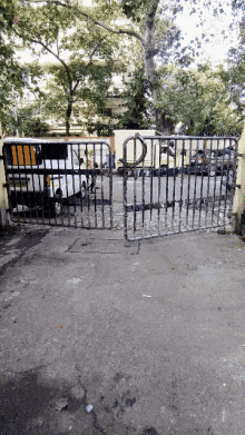 a broken gate with the letter d on it is open