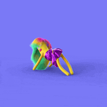 a yellow doll with rainbow hair and a purple tutu