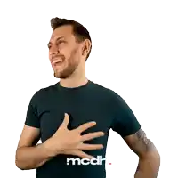 a man wearing a black shirt that says mcdh