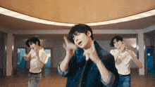 a group of young men are dancing in a large room