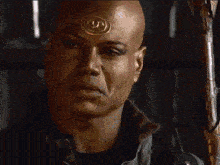 a bald man with a circle on his forehead says indeed