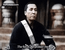 a man is standing in front of a building and says `` the force did protect me . ''