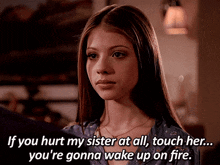 a woman with a quote that says if you hurt my sister at all touch her you 're gonna wake up on fire