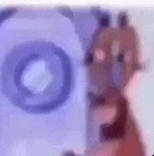 a blurred image of a cartoon character with a purple object in the background .