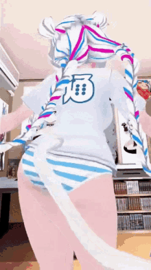 a girl in a white shirt with the number 3 on the back is standing in a room