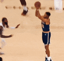 a basketball player with the number 10 on his jersey is jumping in the air