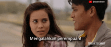a man and a woman are standing next to each other with the words mengalahkan perempuan behind them